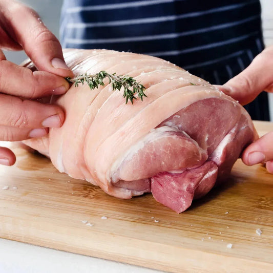 Pork joint hand from Primrose Herd, showing a fresh, well-trimmed hand of pork with visible marbling and bone details.