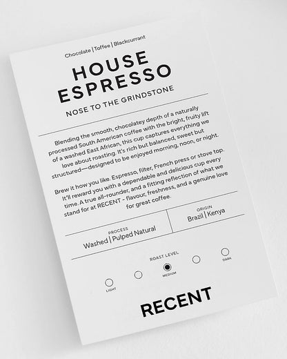 Recent Beans Nose To The Grindstone medium roast coffee in a bag with a label featuring coffee beans and brewing instructions.