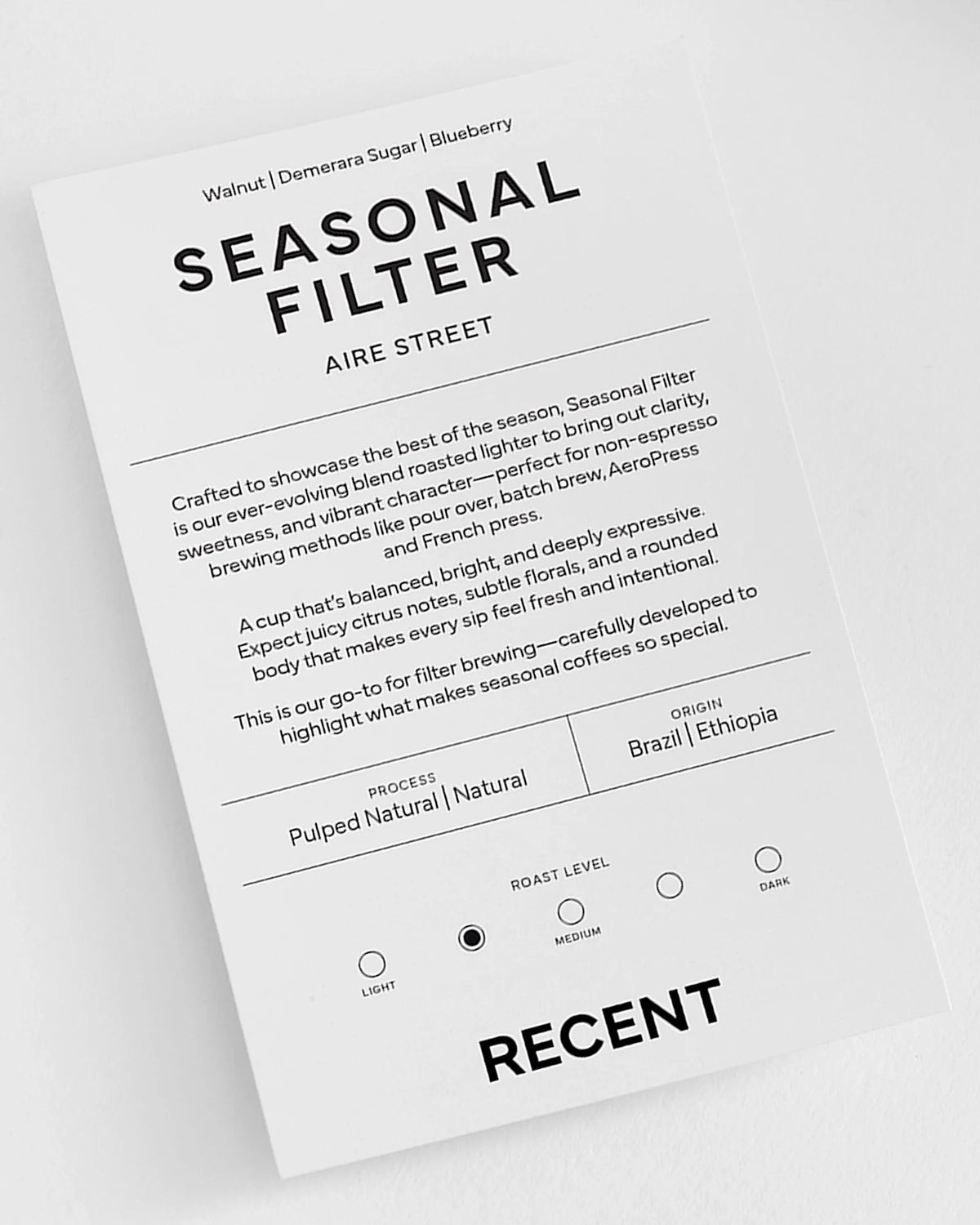Seasonal filter image featuring Recent Beans Aire Street Blend Light Medium Roast Coffee in a bag with coffee beans and brewing setup.
