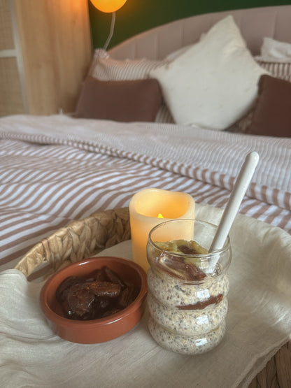 Creamy overnight oats in a glass jar topped with fresh berries and chia seeds, made by Gurt Lush Food Co.