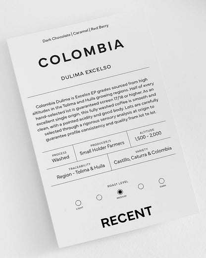 Medium roast Colombia Dulima Excelso coffee beans from Recent Beans, showcasing whole roasted coffee beans in a close-up image.