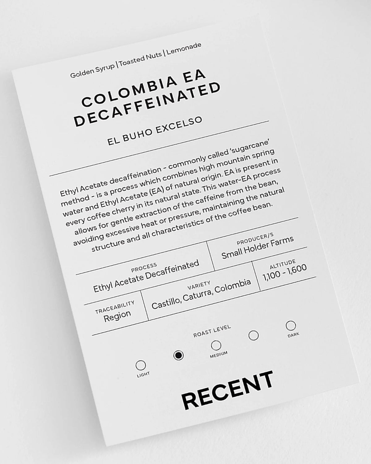 Medium roast decaffeinated Colombia coffee beans from Recent Beans, displayed in a fresh, natural setting.