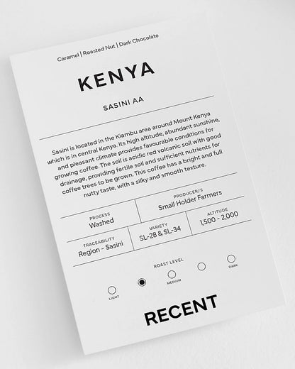 Kenyan Sasini AA medium roast coffee beans by Recent Beans, showing a close-up of roasted coffee beans in a jar.