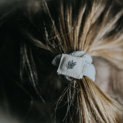 Set of six natural plastic-free hair ties by Wild And Stone, showing eco-friendly, soft elastic hair accessories on a neutral background.