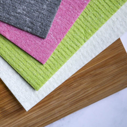 Set of four compostable Swedish dish cloths from Wild And Stone with colorful, patterned designs on soft, absorbent fabric.