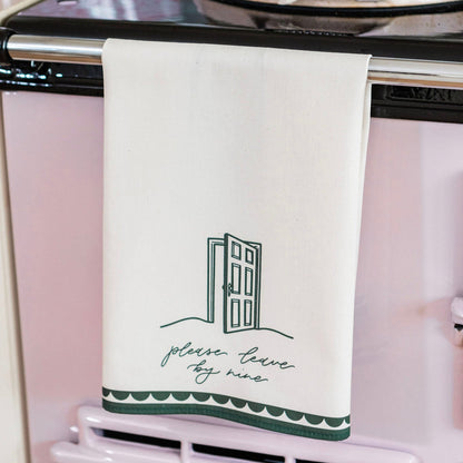 Avalon Home UK "Please Leave By Nine" tea towel with printed text and decorative design, made of soft fabric.