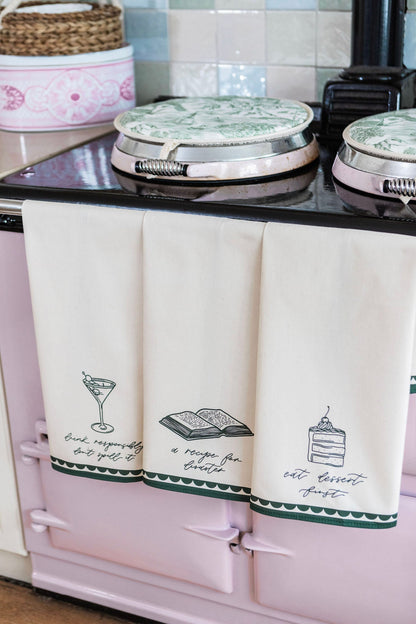 Avalon Home UK recipe for disaster tea towel with colorful printed design, hanging on a kitchen hook.