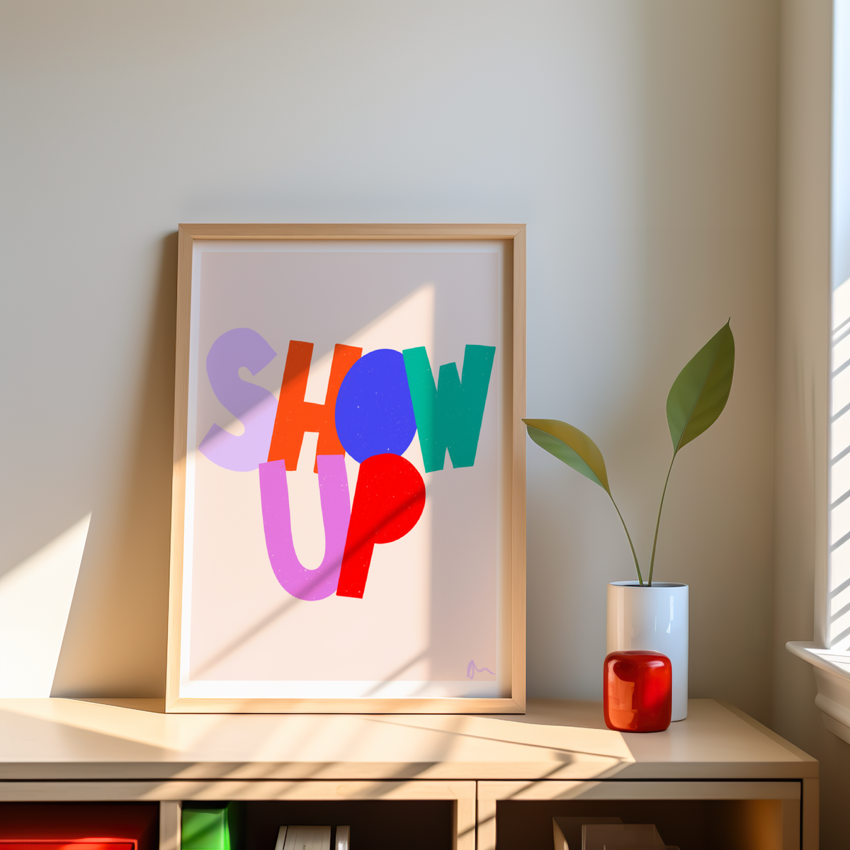 Colorful motivational print art with the slogan "Show Up" by Peak Prints, featuring vibrant design and inspiring message on textured paper.