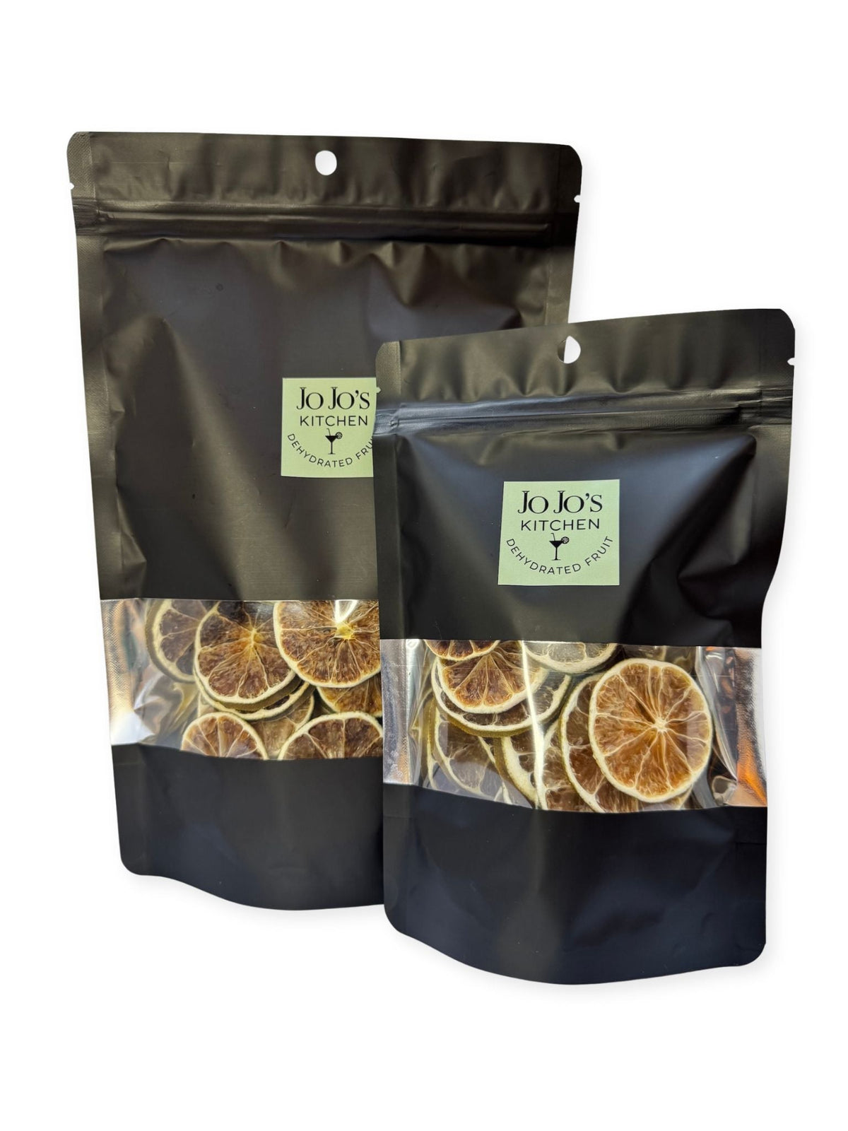 Dried dehydrated lime slices from JoJo’s Kitchen, showing bright green citrus slices with textured surface and slightly curled edges.