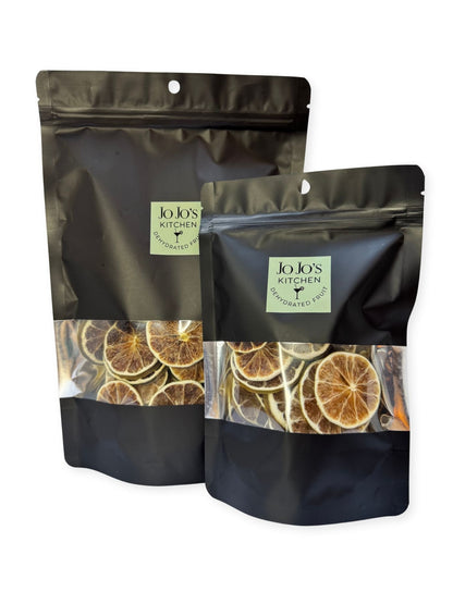 Dried dehydrated lime slices from JoJo’s Kitchen, showing bright green citrus slices with textured surface and slightly curled edges.