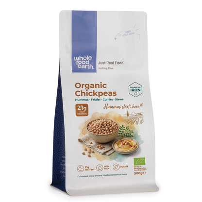 Organic Whole Food Earth chickpeas in a bowl, showing their round beige appearance and textured surface, ideal for cooking or snacking.