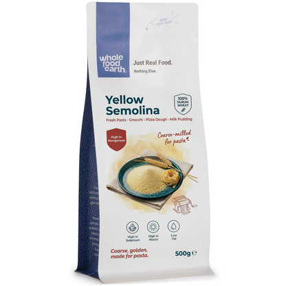 Yellow semolina from Whole Food Earth, a versatile flour and grain product, shown in a clear container on a kitchen countertop.