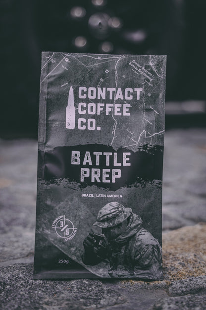 A close-up of a bag of ArtisanBox Battle Prep Coffee with label showing coffee beans and brewing instructions.