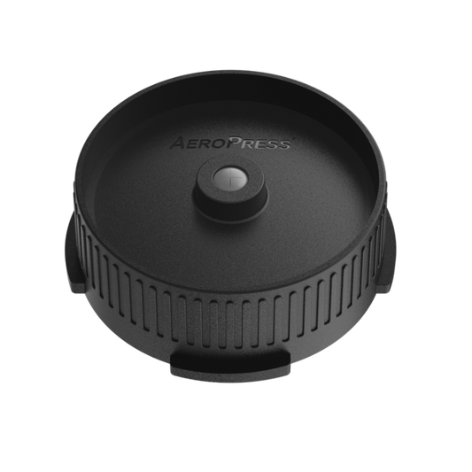 AeroPress Flow Control Filter Cap from Contact Coffee Company Ltd. showing the black plastic gear component with flow control features.