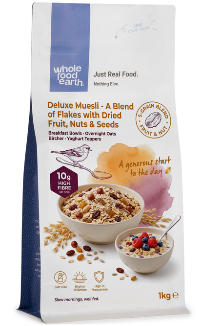 Whole Food Earth Deluxe Muesli cereal with flakes, dried fruit, nuts, and seeds in a bowl for healthy breakfast.