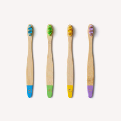 Children's bamboo toothbrushes in a 4-pack with multi-color handles, eco-friendly and suitable for kids, by Wild And Stone.