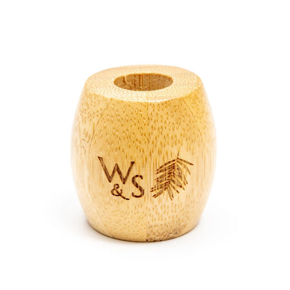 Wild and Stone bamboo toothbrush stand for adults, showcasing a sleek, eco-friendly holder with three slots for toothbrushes.