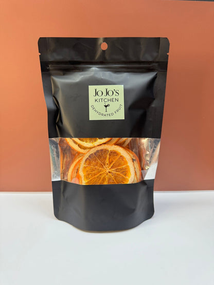 Dehydrated orange slices from JoJo’s Kitchen, showing bright orange, textured slices perfect for snacks or garnishes.