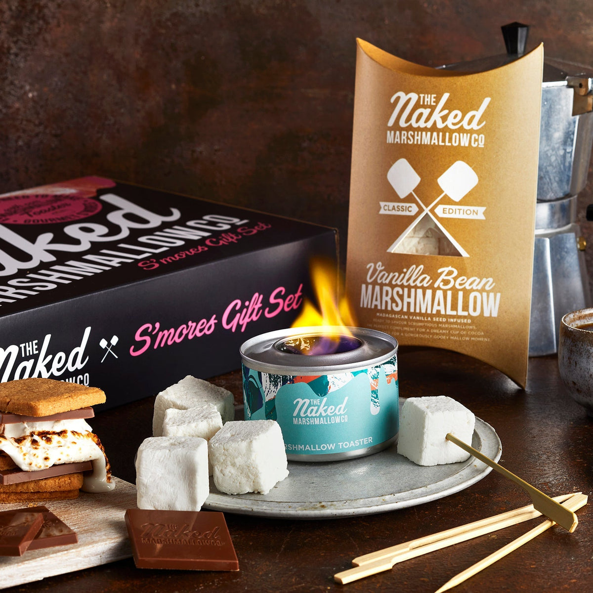 Assorted luxury marshmallows from THE MARSHMALLOW FACTORY displayed in a gift set, featuring fluffy, gourmet s'mores ingredients.