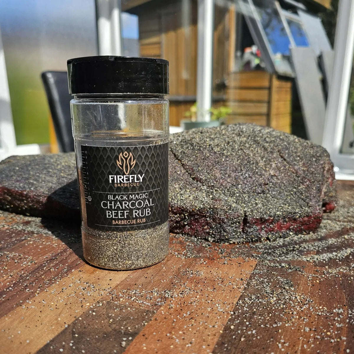 FireFly Barbecue Black Magic Charcoal Beef Rub in a jar, ready for grilling with a smoky, flavorful seasoning blend.