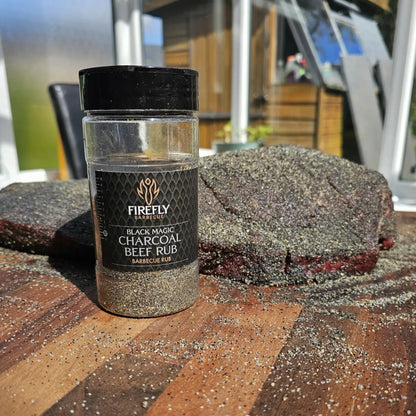 FireFly Barbecue Black Magic Charcoal Beef Rub in a jar, ready for grilling with a smoky, flavorful seasoning blend.