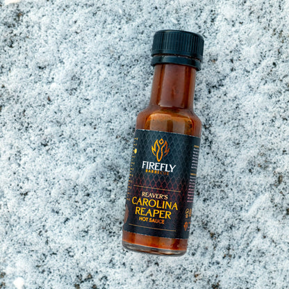 FireFly Barbecue Carolina Reaper Hot Chili Sauce bottle with fiery red sauce and spicy chili peppers on the label.