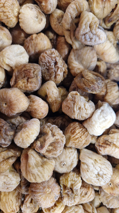 Dried baby figs snack by Whole Food Earth, close-up of small, ripe dried figs with wrinkled skin in a bowl.