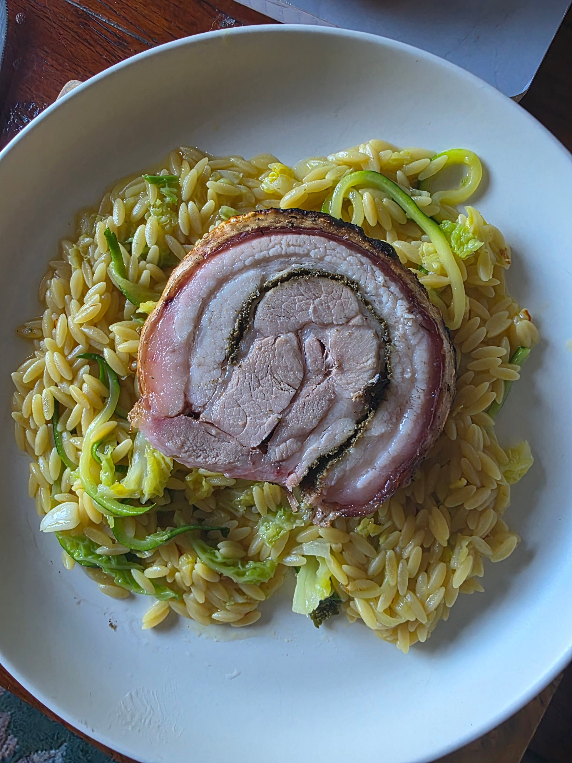Italian Porchetta BBQ Rub by FireFly Barbecue in a jar with herbs and spices, used for seasoning grilled meats.