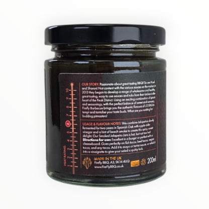 FireFly Barbecue smoked jalapeño jam jar, showcasing glossy, spicy hot sauce with hints of smoke and jalapeño peppers.
