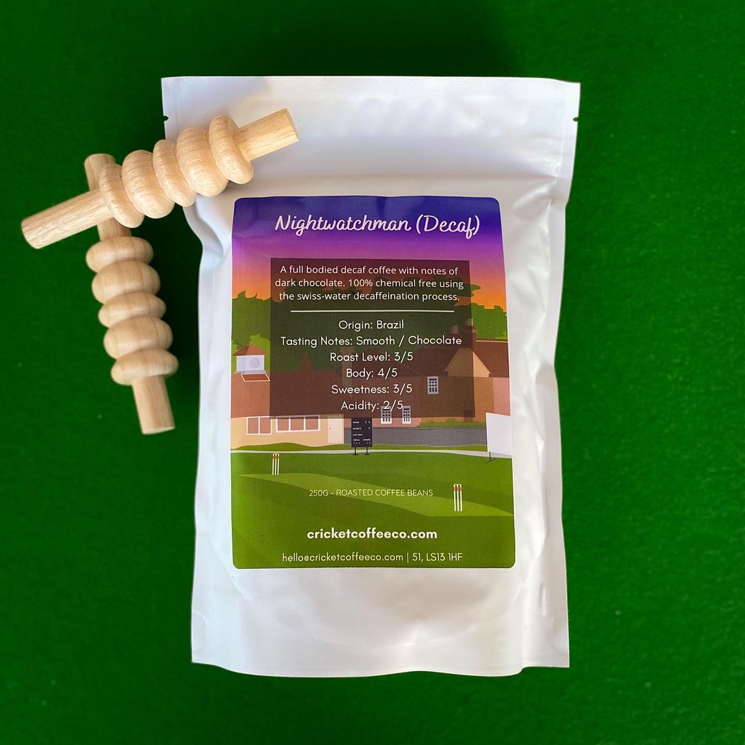 Decaf Nightwatchman coffee by Clubhouse Roastery in a bag, showcasing rich roasted beans and packaging design.