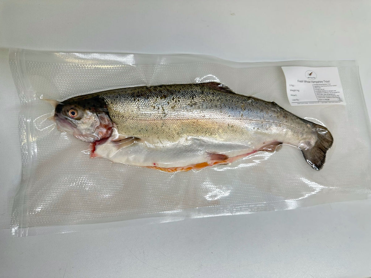 Fresh whole rainbow trout from Butler Country Estates, displayed on a bed of ice with vibrant, shiny skin and clear eyes.