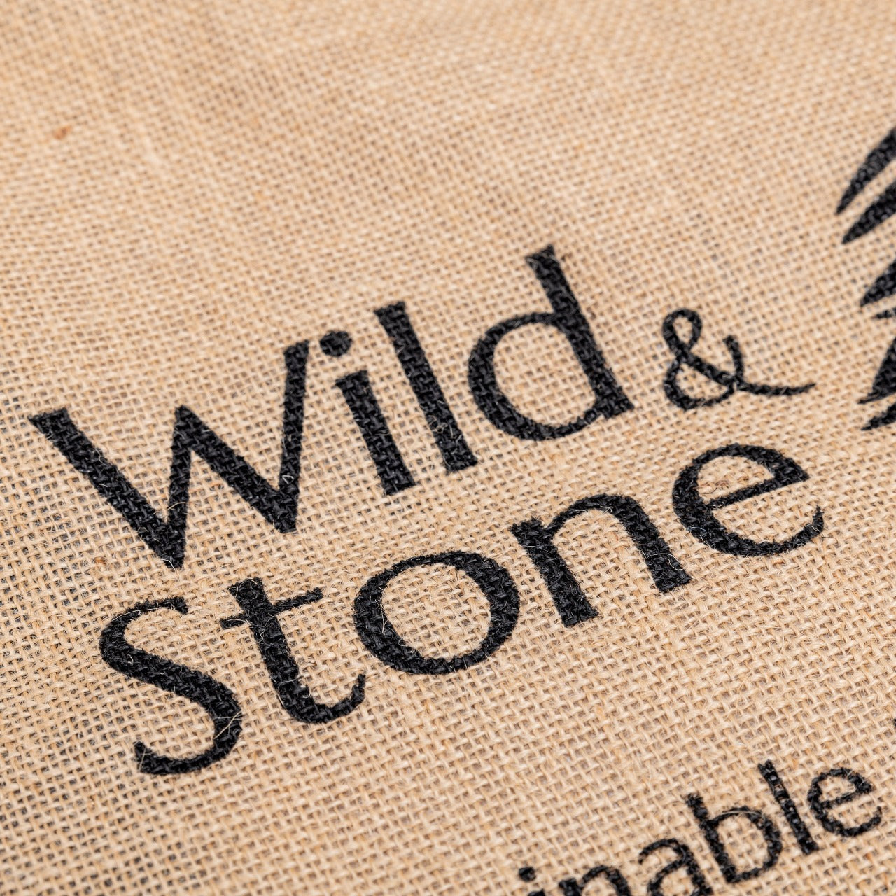 Natural jute Hessian shopping bag from Wild And Stone, featuring sturdy handles and eco-friendly design.