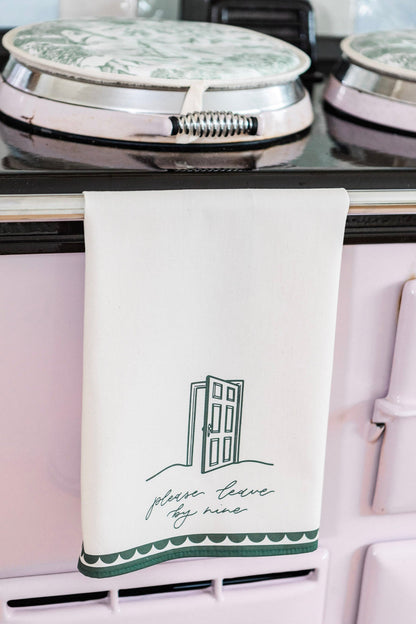 Avalon Home UK Please Leave By Nine tea towel with printed text, featuring a white fabric design for kitchen decor.