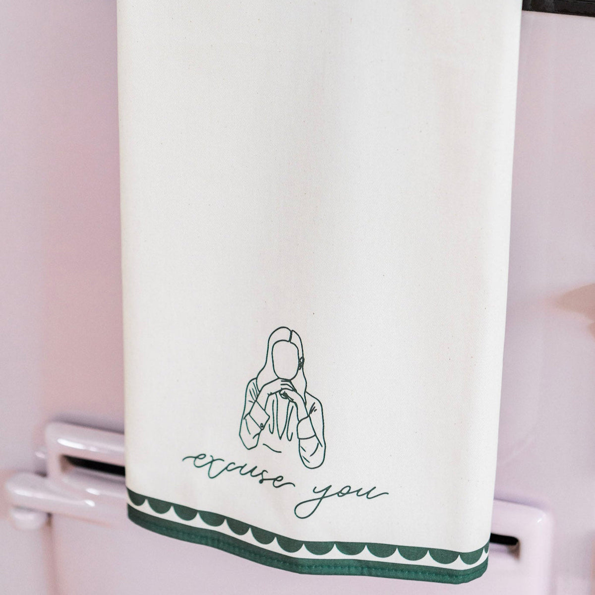 Avalon Home UK excuse you tea towel with playful printed text, shown draped over a kitchen counter.