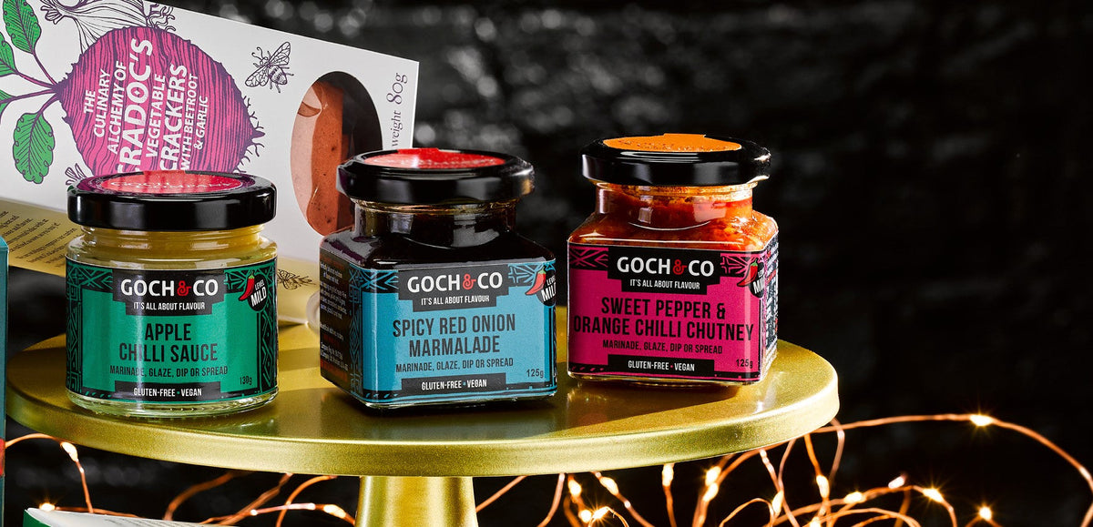 Goch & Co Celebration Hamper with assorted food items, including chocolates, crackers, and festive treats in a decorative gift box.