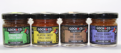 Set of four Goch & Co Goch Chilli Sauces in 45g bottles, showcasing vibrant chili sauces in clear glass bottles.
