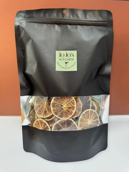 Thin dehydrated lime slices from JoJo’s Kitchen displayed in a close-up image.