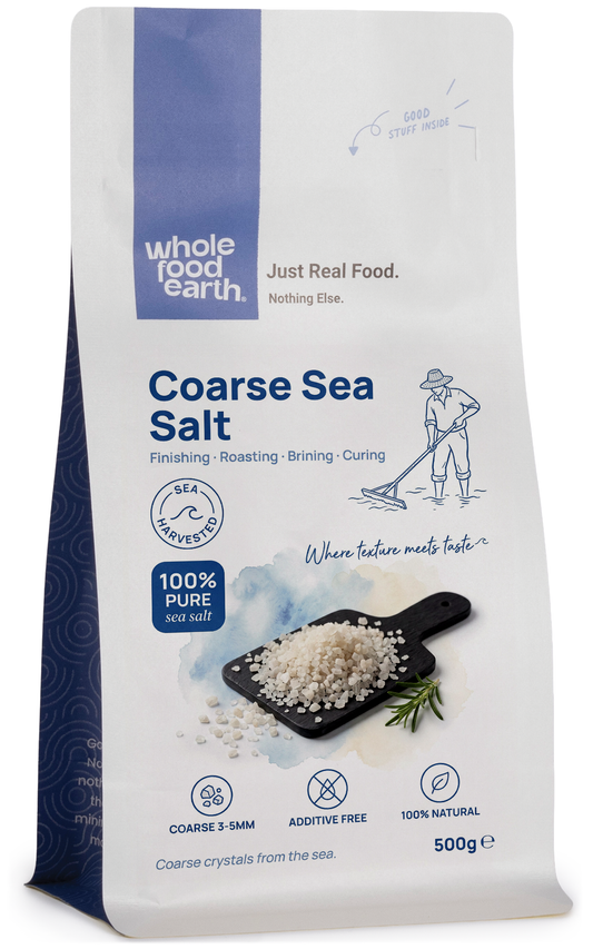 Coarse sea salt from Whole Food Earth, mineral and salt product, showing large crystalline grains on a white background.