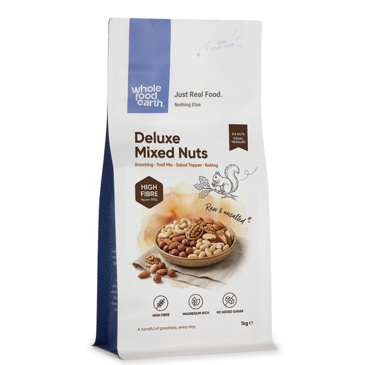 Mixed nuts in a clear bowl featuring almonds, cashews, and walnuts, from Whole Food Earth Deluxe Mixed Nuts specialty product.