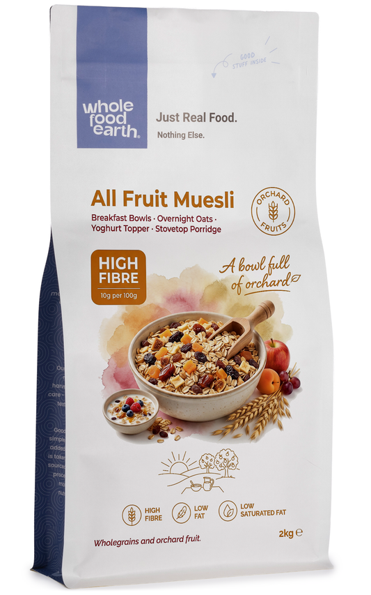 Whole Food Earth All Fruit Muesli cereal and granola in a bowl with colorful dried fruits and grains, close-up shot.