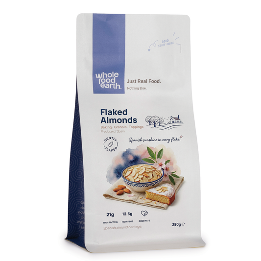 Whole Food Earth flaked almonds, crunchy sliced nuts and seeds, showing golden, toasted almond flakes in a clear container.