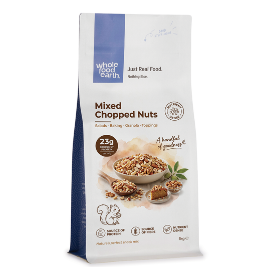 Mixed chopped nuts from ArtisanBox, featuring a variety of chopped almonds, walnuts, and cashews in a clear bowl.
