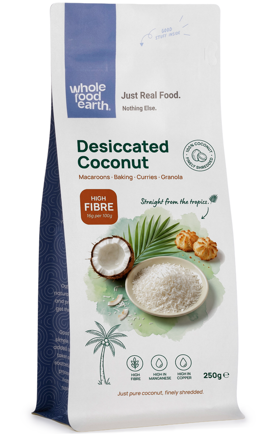 Whole Food Earth desiccated coconut, shredded dried coconut flakes, in a clear container, for baking and cooking.