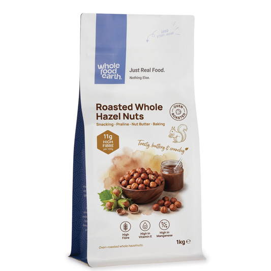 Roasted whole hazelnuts from Whole Food Earth, showing golden-brown nuts with textured shells in a close-up view.