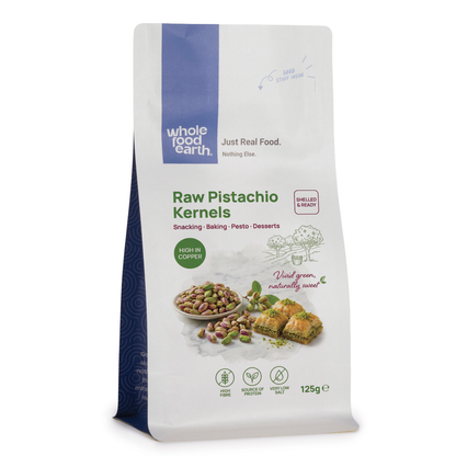 Raw pistachio kernels from Whole Food Earth, close-up of fresh, shelled nuts in a natural setting, ideal for snacking or baking.