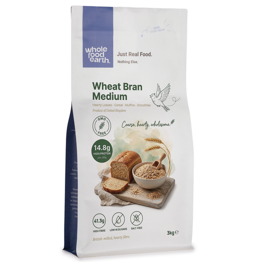 Whole Food Earth wheat bran medium cereal in a clear bowl, showing the light brown, textured bran flakes on a white background.