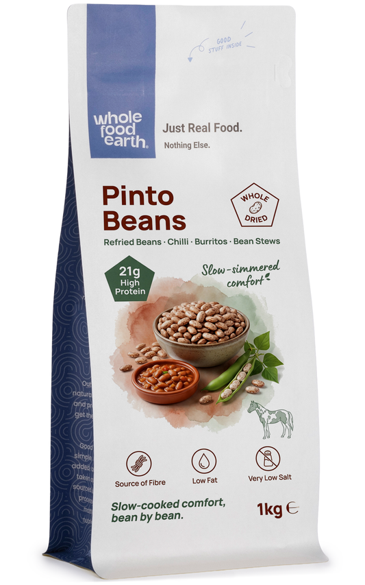 Whole Food Earth Pinto Beans, dried legumes with smooth, reddish-brown shells, shown in a close-up image.