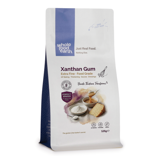 Whole Food Earth xanthan gum, specialty food ingredient, in a white powder form suitable for baking and thickening purposes.