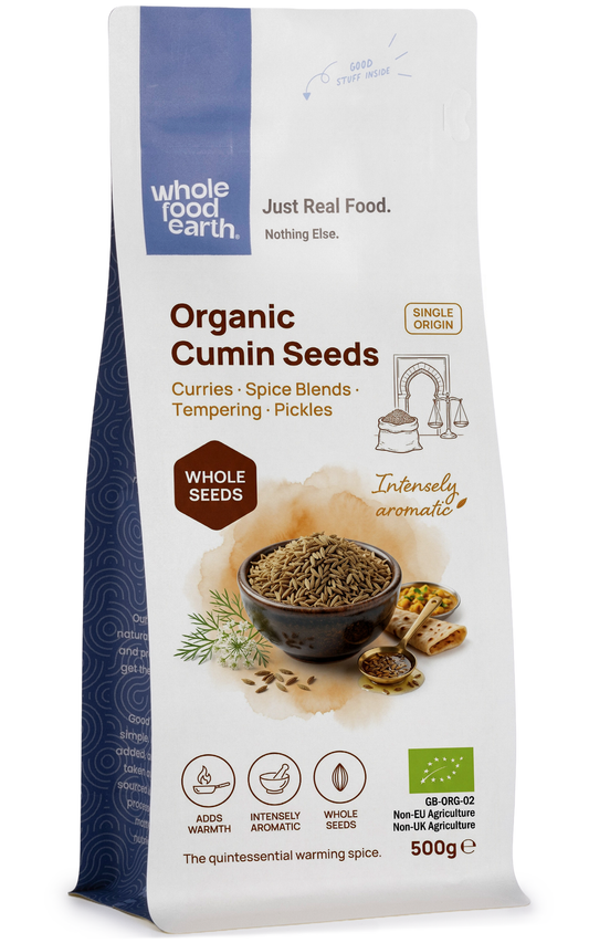 Organic cumin seeds from Whole Food Earth, close-up of small brown seeds with ridged surface, used as herbs and spices.