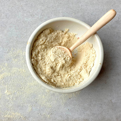 Freeze dried mango powder from Whole Food Earth, vibrant orange dried fruit powder in a clear container.